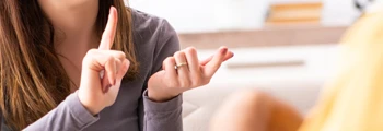 Woman using British Sign Language during a conversation.